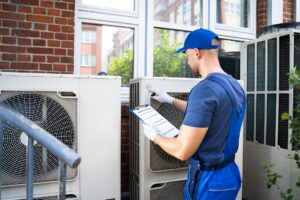 Air-conditioner-technician-inspecting-outdoor-ac-cabinet