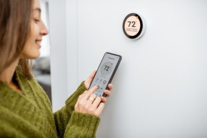 person-using-smart-thermostat